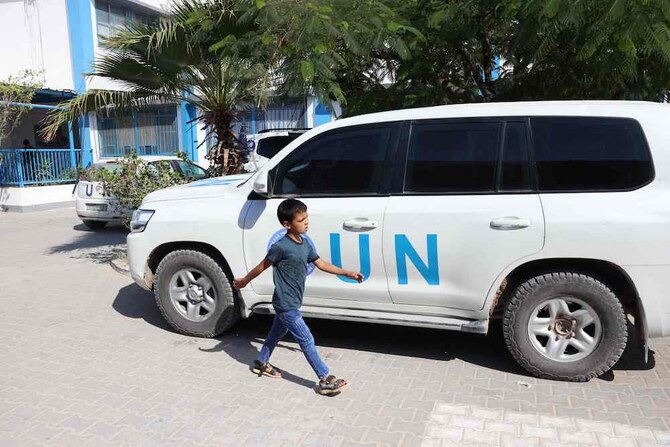 A Palestinian boy walks past a UN vehicles at the UNRWA Japanese Health Center in Khan Yunis on the southern Gaza Strip on October 29, 2024. (AFP)