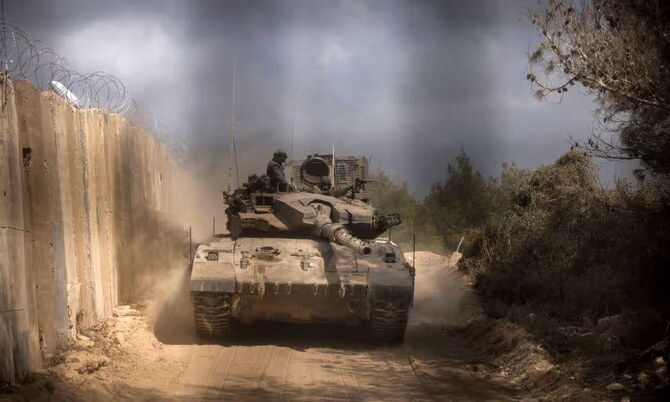 An Israeli tank enters Lebanon, from northern Israel, at the Naqoura border point, Oct. 13, 2024. (AFP)