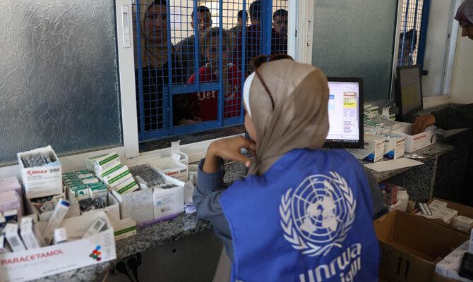 Palestinians queue to receive medicine at the UNRWA Japanese Health Center in Khan Yunis on the southern Gaza Strip on October 29, 2024, amid the ongoing war between Israel and the Palestinian militant group Hamas. (AFP)
