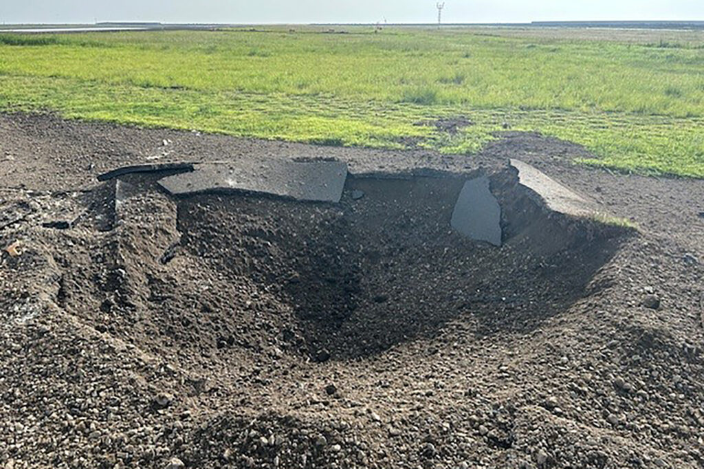 This recent handout photo released to AFP by the Miyazaki Airport Office of the Ministry of Land, Infrastructure, Transport and Tourism on October 4, 2024 shows a hole several metres wide on the edge of the tarmac after an unexploded World War II US bomb blew up less than a minute after a passenger jet taxied past on October 2 at Miyazaki airport in southern Kyushu island. (AFP)