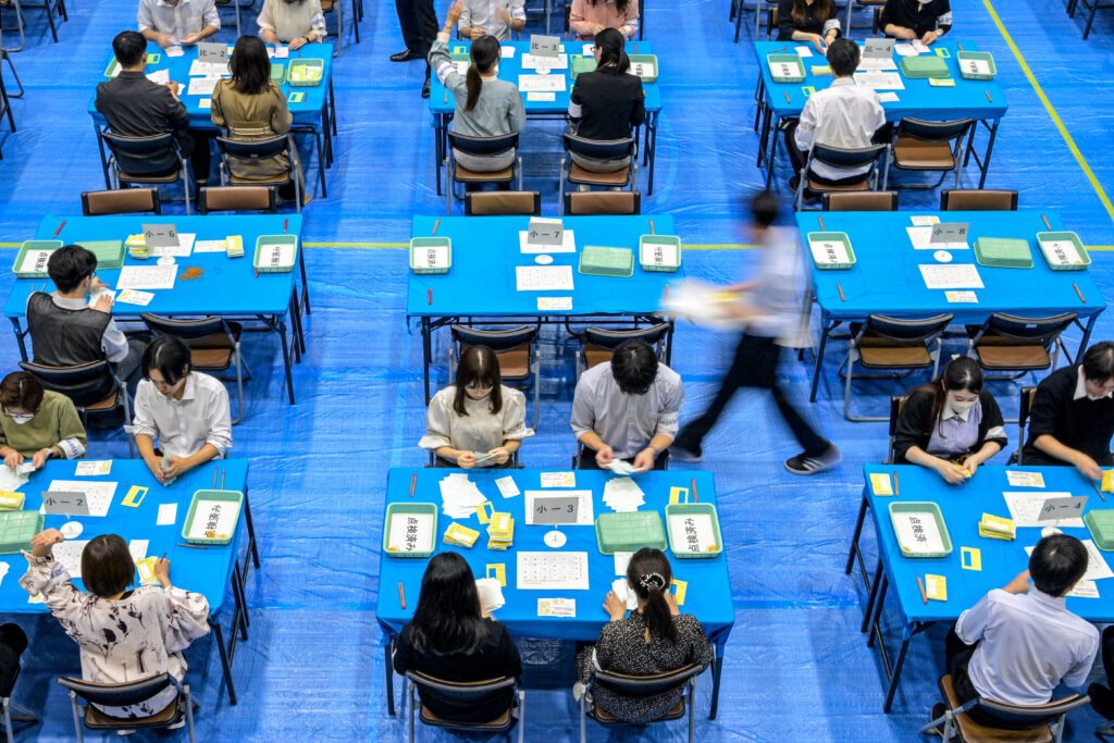 Officials of the election administration committee count ballots for Japan's general election in Tokyo on October 27, 2024. (AFP)