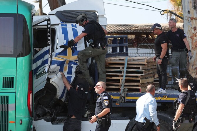 Israeli police inspect the truck at the site of a ramming attack in Glilot, north of Tel Aviv on October 27, 2024. The Israeli emergency service and police said a truck rammed into a bus stop north of the commercial hub Tel Aviv, injuring dozens of people. (AFP)