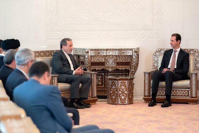 Syria's President Bashar al-Assad (R) meets with Iranian Foreign Minister Abbas Araghchi in Damascus on October 5, 2024. (AFP)