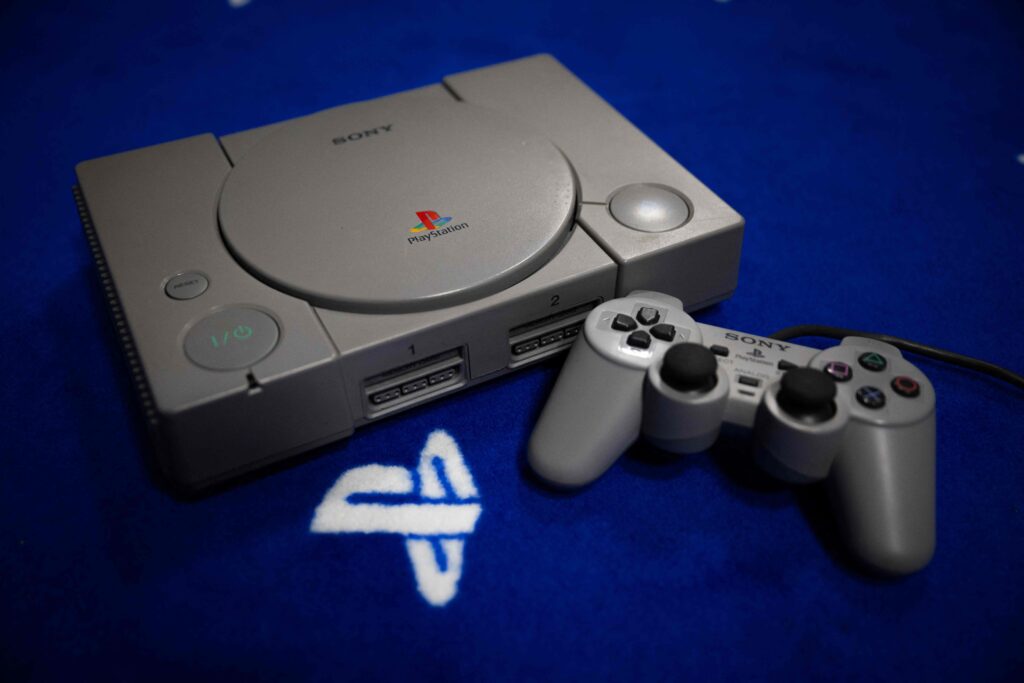This photograph shows a PlayStation 1 console and controller, in Vraiville, northern France, on November 20, 2024. (AFP)