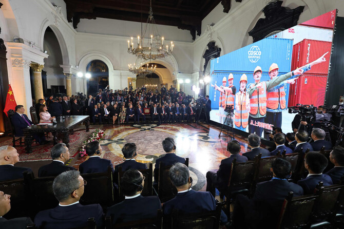China's President Xi Jinping (L) and Peru's President Dina Boluarte applaud during the virtual inauguration ceremony of the Chancay 