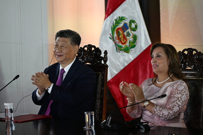 China's President Xi Jinping (L) and Peru's President Dina Boluarte attend the virtual inauguration ceremony of the Chancay 