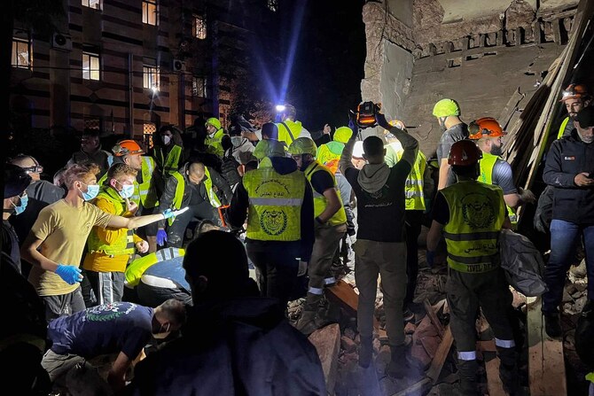 Emergency teams work at the site of an Israeli strike that targeted Zuqaq Al-Blat neighbourhood in Beirut, on November 18, 2024. (AFP)