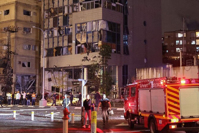 Israeli emergency services work following a rocket attack from southern Lebanon in Ramat Gan, north of Tel Aviv, on November 18, 2024. (AFP)