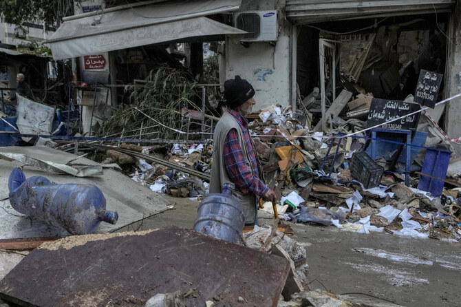 A man passes in front of a destroyed building hit on Monday evening by an Israeli airstrike in central Beirut, Lebanon, Tuesday, Nov. 19, 2024. (AP)