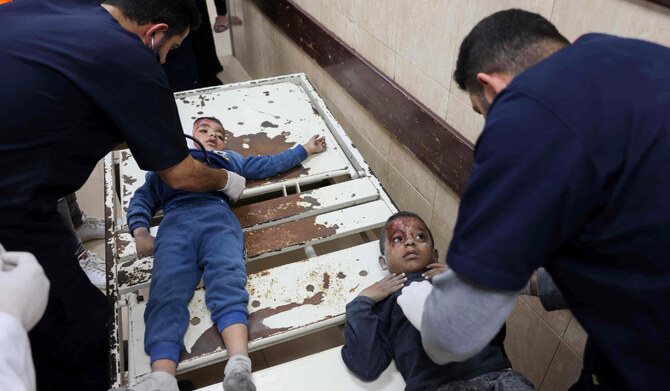 Medics tend to two wounded boys at al-Aqsa Martyrs Hospital in Deir Al-Balah in the central Gaza Strip on November 19, 2024, follwoing an Israeli strike in Bureij, amid the ongoing war between the Palestinian Hamas militant group and Israel. (AFP)
