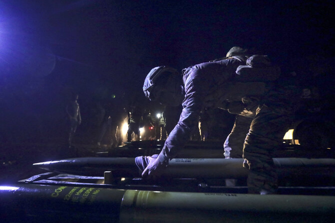 This picture taken on October 23, 2024 shows Turkish-backed Syrian fighters preparing rockets at a position in the Afrin region in the rebel-held part of Syria's northern Aleppo province, to be fired towards areas in northeastern Syria controlled by the Kurdish-led Syrian Democratic Forces. (AFP/File)