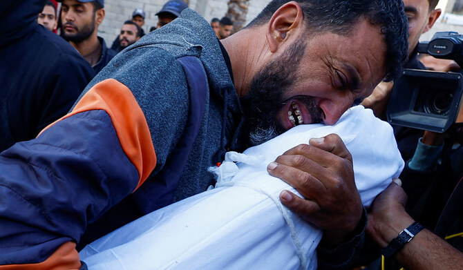 A father reacts holding the body of his son killed in an Israeli strike, at Nasser hospital in Khan Younis in the southern Gaza Strip, November 23, 2024. (REUTERS)