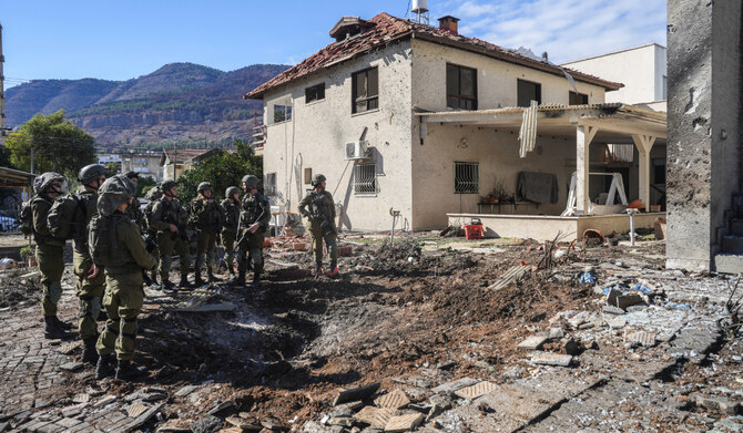 Israeli soldiers stand at the site where a house was damaged, after Israel's military reported projectiles crossing over to Israel from Lebanon, amid hostilities between Hezbollah and Israeli forces, in Kiryat Shmona, northern Israel, November 26, 2024. (REUTERS)