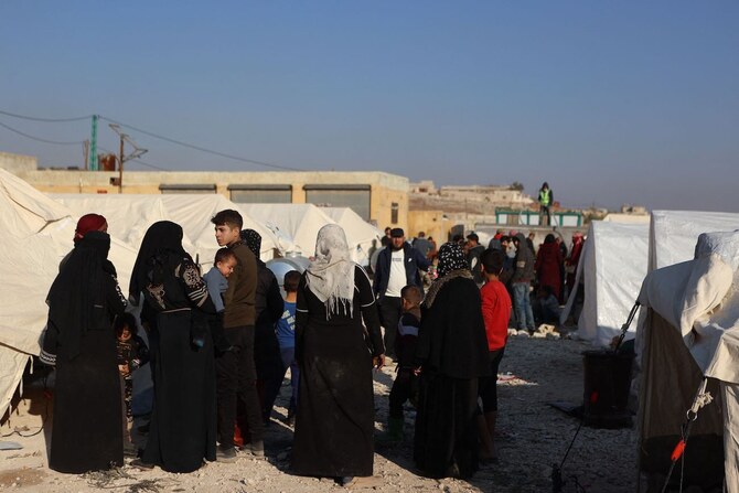 Displaced families, who fled the current battles in the western countryside of Aleppo, arrive at a shelter in village of Berdakli on outskirts of the town of Al-Dana in Idlib province on November 28, 2024. (AP)