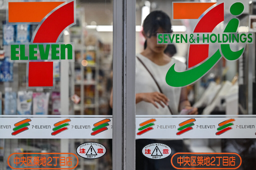 Customers are seen inside a 7-Eleven convenience store along a street in central Tokyo on September 9, 2024. (AFP)