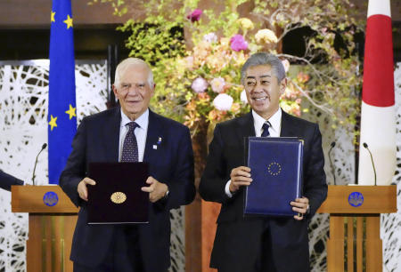 Japanese Foreign Minister Takeshi Iwaya (right), shakes hands with European Union foreign policy chief Josep Borrell during a photo at the foreign ministry's guest house in Tokyo, Friday, Nov. 1, 2024. (Kyodo News via AP)