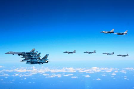 This handout photo taken on November 3, 2024 and provided by the US Air Force via South Korean Defence Ministry shows a US Air Force B-1B bomber (L), South Korean Air Force F-15K fighter jets (C), Japanese Air Self-Defense Force F-2 fighter jets (bottom L) and US Air Force F-16 fighter jets (top R) flying in formation during a joint air drill in the eastern airspace of the South Korean southern island of Jeju. (AFP)