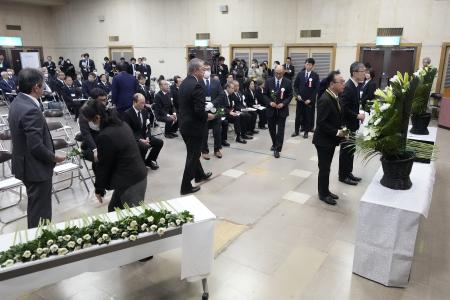 Guests offer a moment of silence during a memorial ceremony for the Sado Island Gold Mine in Sado, Niigata prefecture, Japan, Sunday, Nov. 24, 2024. (AP)