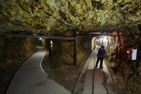 A visitor walks through tunnels at Sado Kinzan Gold Mine historic site in Sado, Niigata prefecture, Japan, Sunday, Nov. 24, 2024. (AP)