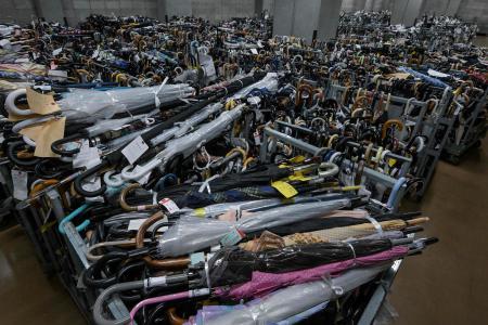 This photo taken on August 2, 2024 shows thousands of umbrellas -- all tagged and organised based on where and when they were lost -- in containers at the Tokyo Metropolitan Police Department Lost and Found Centre in the Iidabashi area of central Tokyo. (AFP)