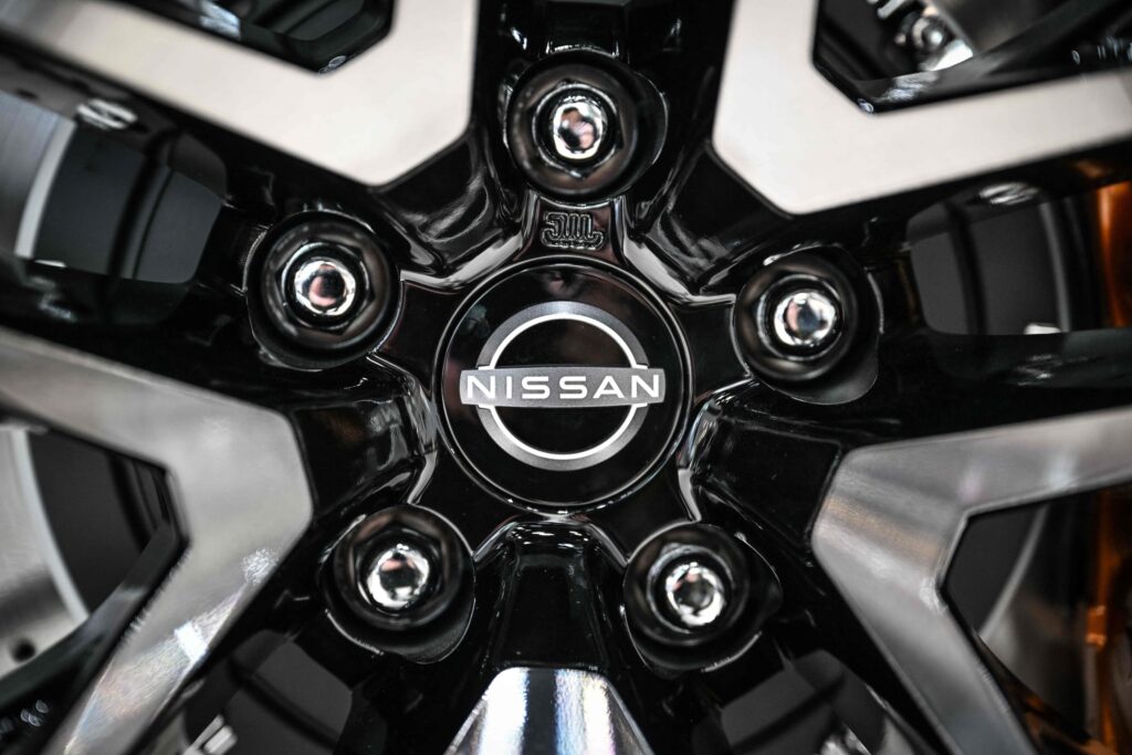 The emblem of Japanese automaker Nissan Motor is seen at a showroom in Yokohama on May 9, 2024. The Tokyo Stock Exchange temporarily suspended trading of Nissan shares on December 18, 2024 after several media outlets reported the auto giant would enter merger talks with Honda. (AFP)