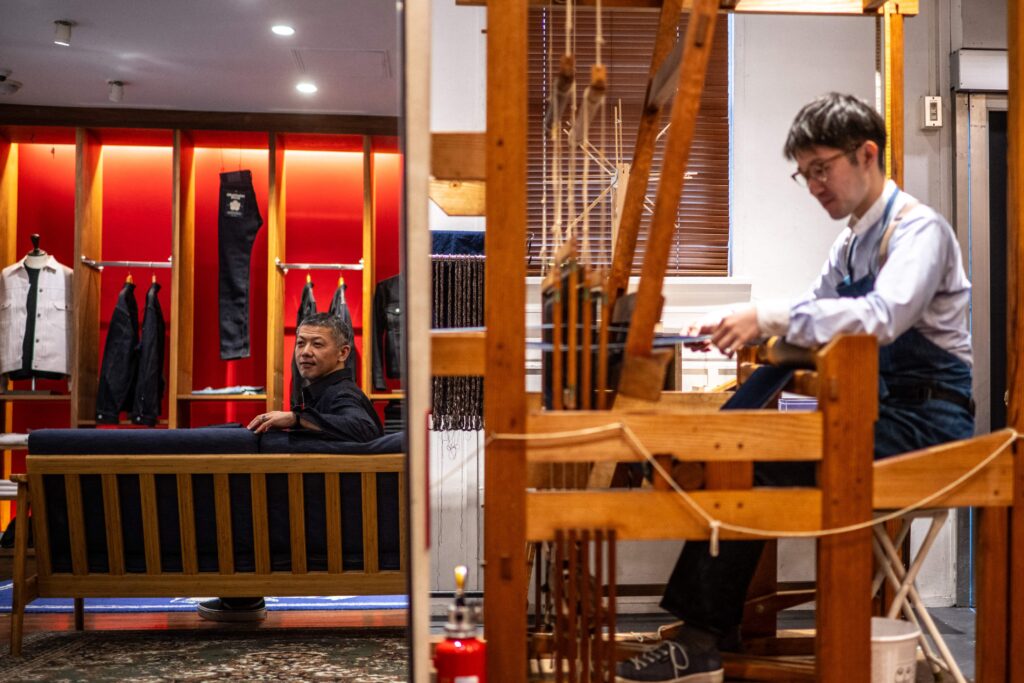 This picture taken on September 4, 2024 shows Masataka Suzuki, president of Momotaro Jeans, posing during an interview with AFP in the Kojima district of Okayama. Call it an antidote to fast fashion: Japanese jeans hand-dyed with natural indigo and weaved on a clackety vintage loom, then sold at a premium to global denim connoisseurs. (AFP)