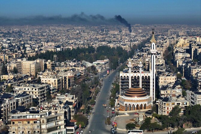 This aerial view shows a deserted street in Aleppo with smoke rising in the background after militants and their allies entered the northern Syrian city on November 30, 2024. (AFP)