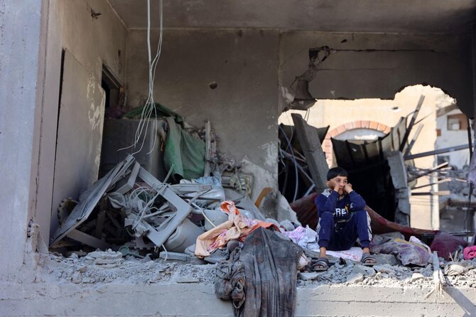 A Palestinian boy watches from a damaged room adjacent to a building destroyed in an Israeli strike on the Shujaiyah neighbourhood in Gaza City in the northern Gaza Strip on November 30, 2024, during the ongoing war between Israel and the Hamas militant group. (AFP)
