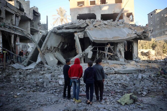 Palestinian children stare at a building destroyed in an Israeli airstrike in Nuseirat in the central Gaza Strip on December 1, 2024. (AFP)