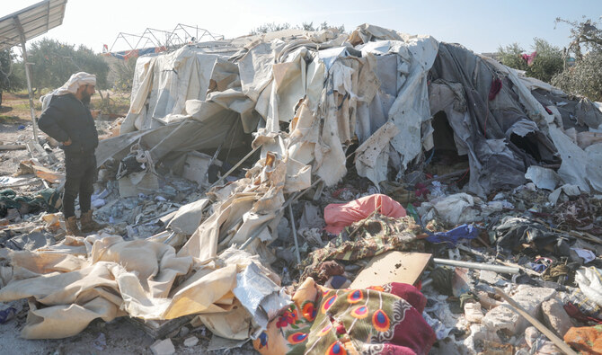 A man looks at a camp for internally displaced people destroyed during an airstrike near the village of Harbnush, north of Idlib, Syria. (AP)