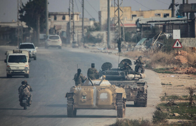 Militants led by the Islamist militant group Hayat Tahrir al-Sham drive along a street in al-Rashideen, Aleppo province, Syria November 29, 2024. (Reuters)