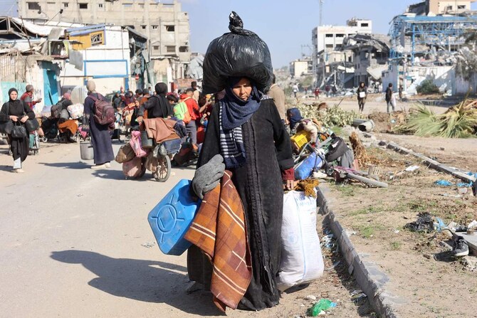 A Palestinian woman, displaced from Beit Lahia, arrives in Jabalia in northern Gaza on December 4. Amnesty International accused Israel of “committing genocide.” (AFP)