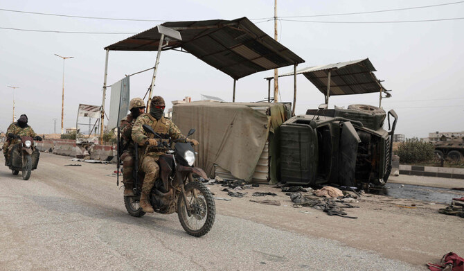 Anti government forces ride past a Syrian military vehicle overturned on the road, after militants took control of the central Hama governorate, on December 7, 2024. (AFP)