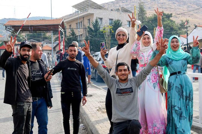 Syrians celebrate as they return to Damascus via Lebanon’s Masnaa border crossing east of Beirut on December 8, 2024, following the fall of the Syrian capital to anti-government fighters. (AFP)