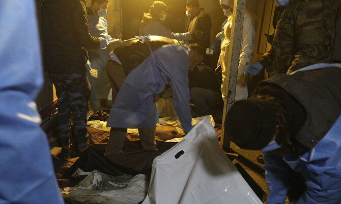 Sanitary servicemen arrange the bodies of dead persons at the morgue of a hospital in Damascus on December 10, 2024. (AFP)