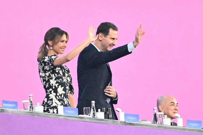 File photo of Syria's President Bashar al-Assad (C) and his wife Asma al-Assad (L) attend the opening ceremony of the 2022 Asian Games at the Hangzhou Olympic Sports Centre Stadium in Hangzhou in China's eastern Zhejiang province on September 23, 2023 (AFP)