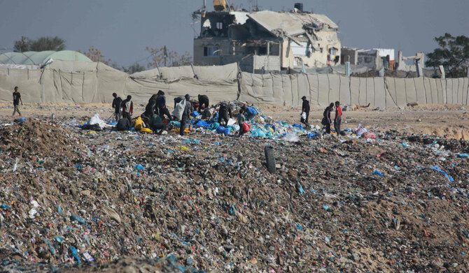 People search for salvageable items at a landfill in Khan Yunis, in the southern Gaza Strip, on December 9, 2024, amid the continuing war between Israel and the Palestinian militant Hamas group. (AFP)