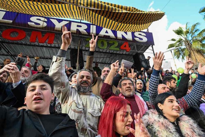 People celebrate the collapse of Bashar Assad’s rule while gathering on a street in Sweida on Dec. 13, 2024. (AFP)