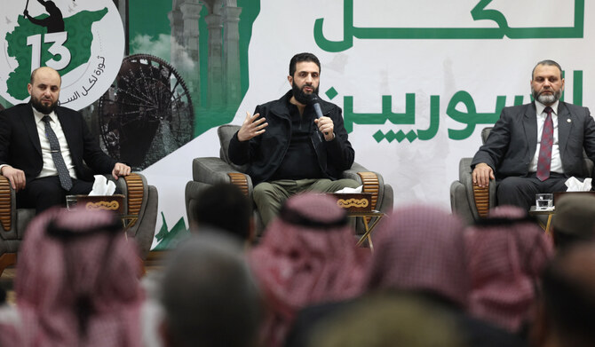Abu Mohamed Al-Jolani (C), head of Hayat Tahrir al-Sham (HTS) speaks during a press conference in the area of Bab al Hawa crossing northern Syria late on March 12, 2024. (AFP)