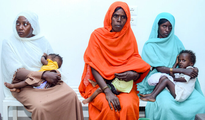 Women with children wait for medical care at the Italian Paediatric Hospital in Port Sudan on October 8, 2024. (AFP)