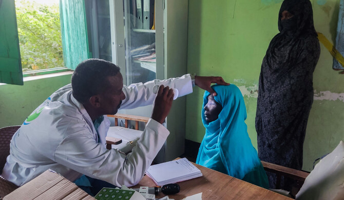 A Sudanese doctor performs a medical check on a patient at a hospital in Tokar in the Red Sea State following recent heavy flooding in eastern Sudan on October 10, 2024. (AFP)