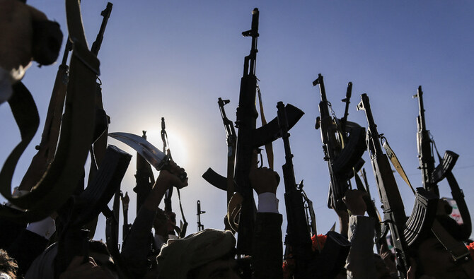 Supporters of Yemen's Houthi group raise up their arms during a rally in the Houthi-controlled capital Sanaa on December 13, 2024. (AFP/File)