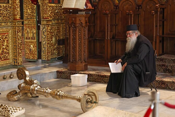 A man sits in the Church of the Nativity in the biblical city of Bethlehem, in the occupied West Bank, on December 17, 2024. (AFP)