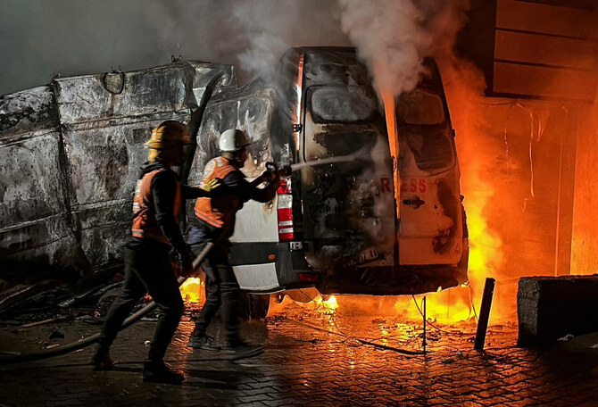 Civil Defense members put out a fire in a broadcast van following an Israeli strike that killed five journalists of Al-Quds Al-Youm television channel, the day before Israel burned parts of Kamal Adwan Hospital. (Reuters)
