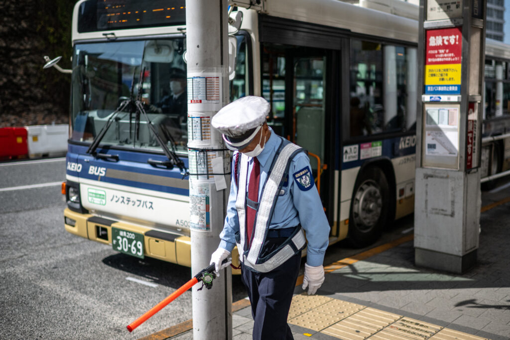 A security guard works in Shinjuku district of Tokyo on March 14, 2024. (Photo by Philip FONG / AFP)