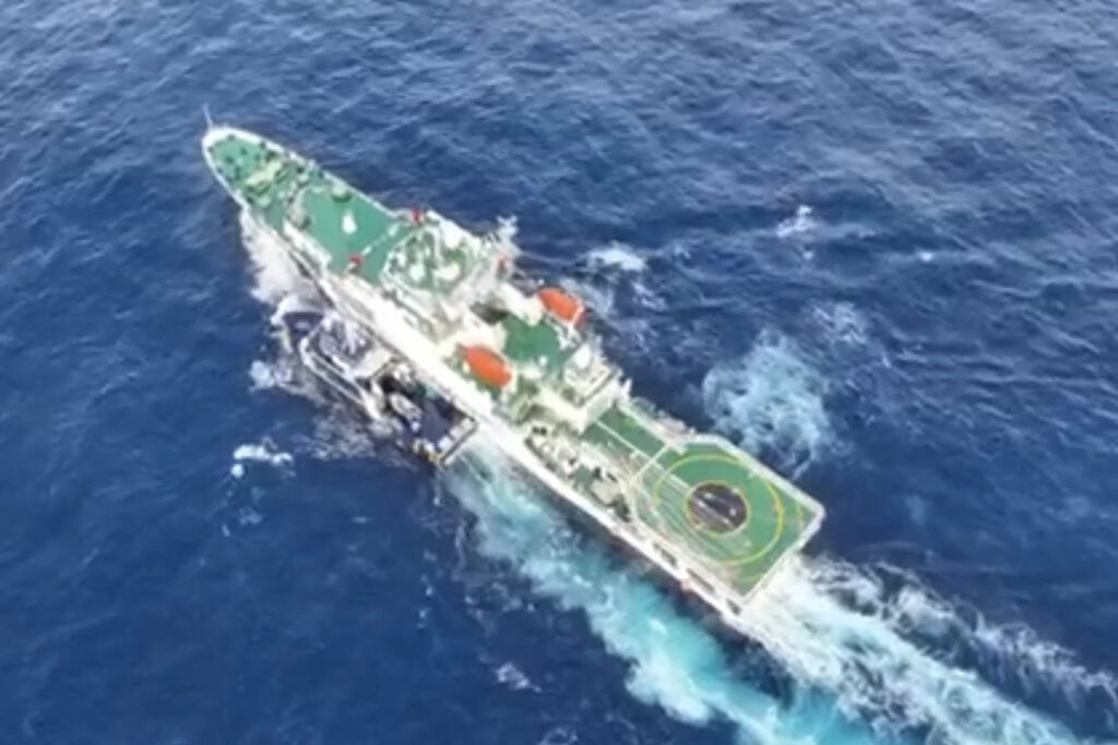This frame grab from handout video footage taken and released on December 4, 2024 by the National Task Force for the West Philippine Sea (NTF-WPS) shows a China Coast Guard ship (R) and the Phillipine Bureau of Fisheries and Aquatic Resources (BFAR) vessel BRP Datu Pagbuaya (L) near Scarborough Shoal in disputed waters of the South China Sea. (AFP)