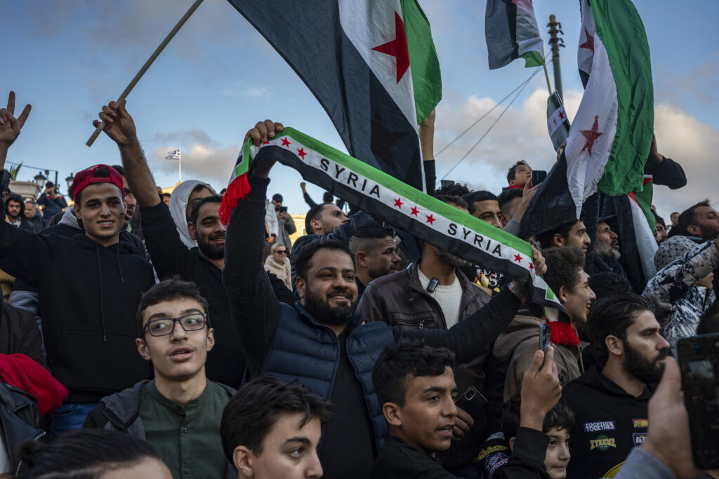 Members of the Syrian community chant slogans as they gather in Syntagma square in Athens to celebrate the end of the regime of Syrian dictator Bashar al-Assad after rebel fighters took control of the Syrian capital Damascus overnight, on December 8, 2024.  (AFP)