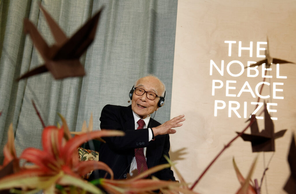 Terumi Tanaka representing the 2024 Nobel Peace Prize winner, the Nihon Hidankyo group, is seen behind paper cranes, symbol of the fight against nuclear weapons and logo of Nihon Hidankyo, as he gives a press conference in Oslo, Norway, on December 9, 2024, on the eve of the Nobel Peace Prize ceremony. (AFP)