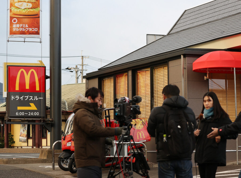 Members of media are seen in front of a McDonald's branch where a junior high school student was stabbed to death in Kitakyushu city. (AFP)