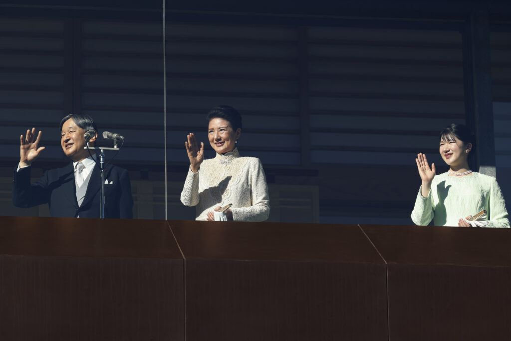 Japan's Emperor Naruhito, from left, Empress Masako and Princess Aiko wave at well-wishers during a public appearance of royal families of Japan for the new year's celebrations at the Imperial Palace in Tokyo, Thursday, Jan. 2, 2025. (Rodrigo Reyes Marin/Pool Photo via AP)